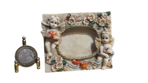 Pequeno porta retrato em resina com decoração de anjos em relevo