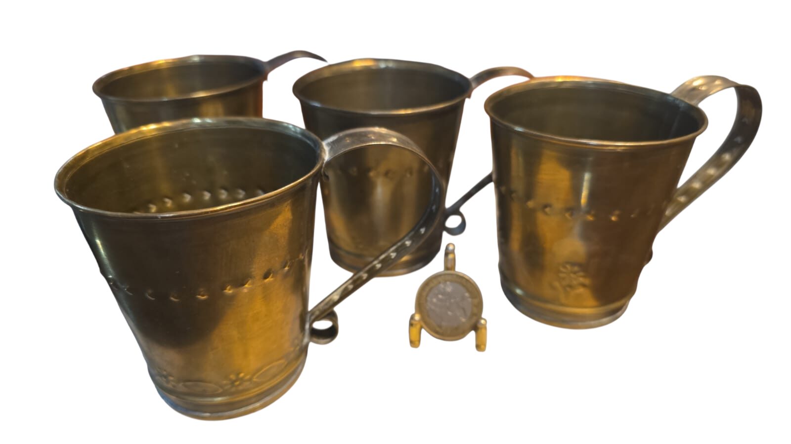 Canecas em dourado metal ornamentadas com motivos florais