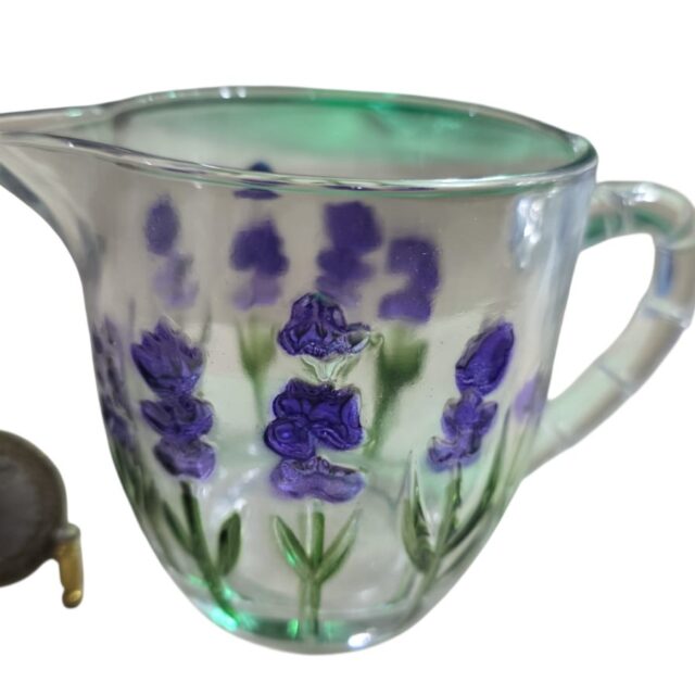 Pequena leiteira de vidro ornamentada com motivos florais